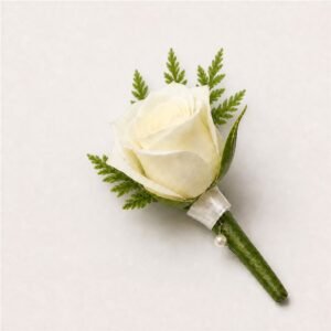 White rose buttonhole with leather fern